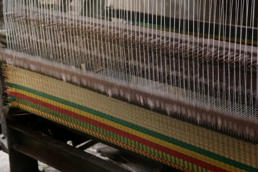 Loom weaving a sedge mat in Dong Thap, Mekong Delta